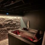Two people relaxing in side-by-side cold plunge tubs at MindFuel’s social wellness studio in Pittsburgh