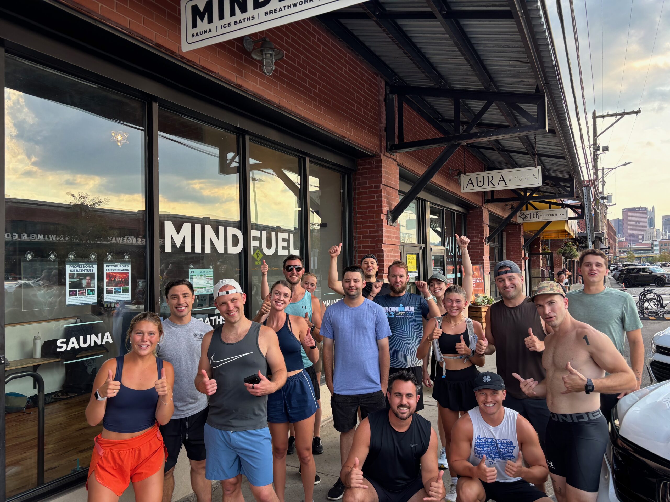 MindFuel Run Club group photo with thumbs up outside the studio