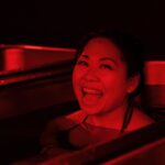 Woman smiling in cold plunge tub at MindFuel Method in Pittsburgh