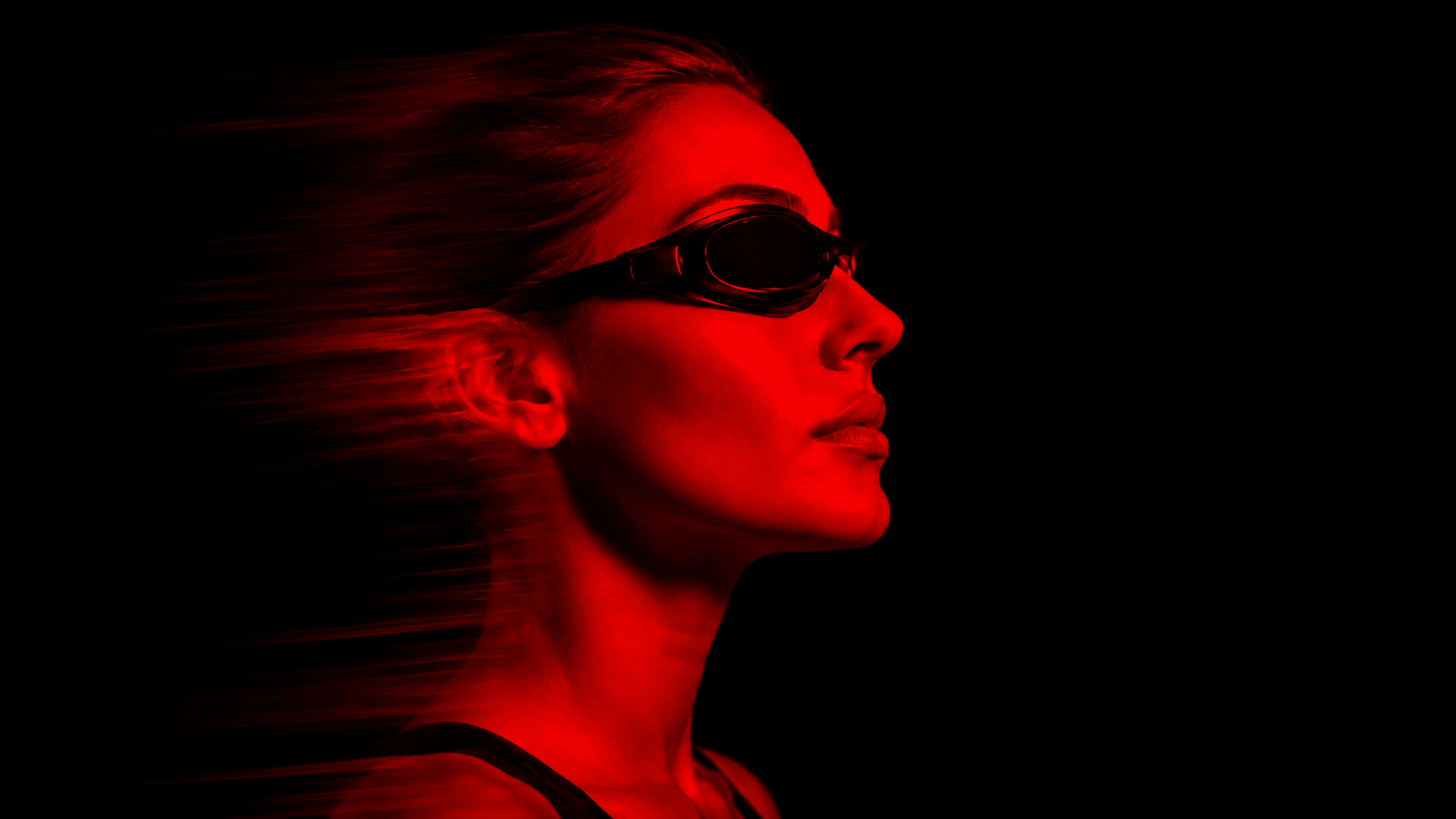 A woman sits in a red light therapy bed at MindFuel Method in the Strip District in Pittsburgh